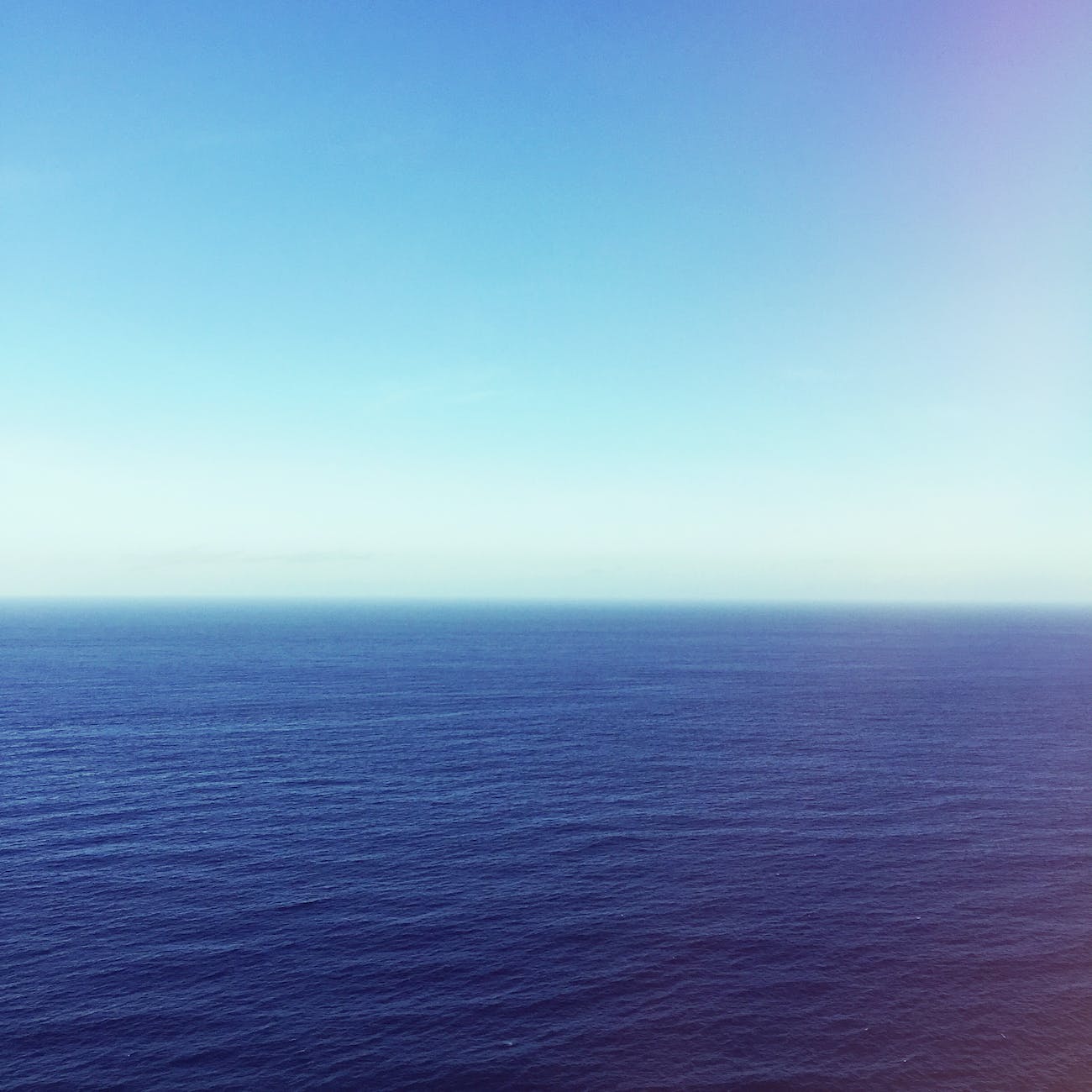 wavy blue ocean under blue sky