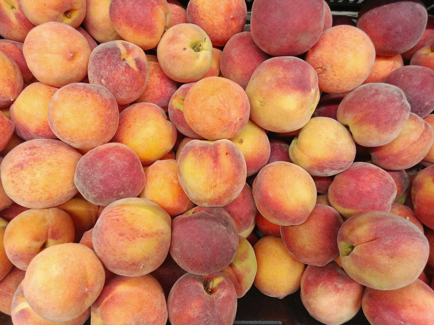 fresh ripe peaches at a market display