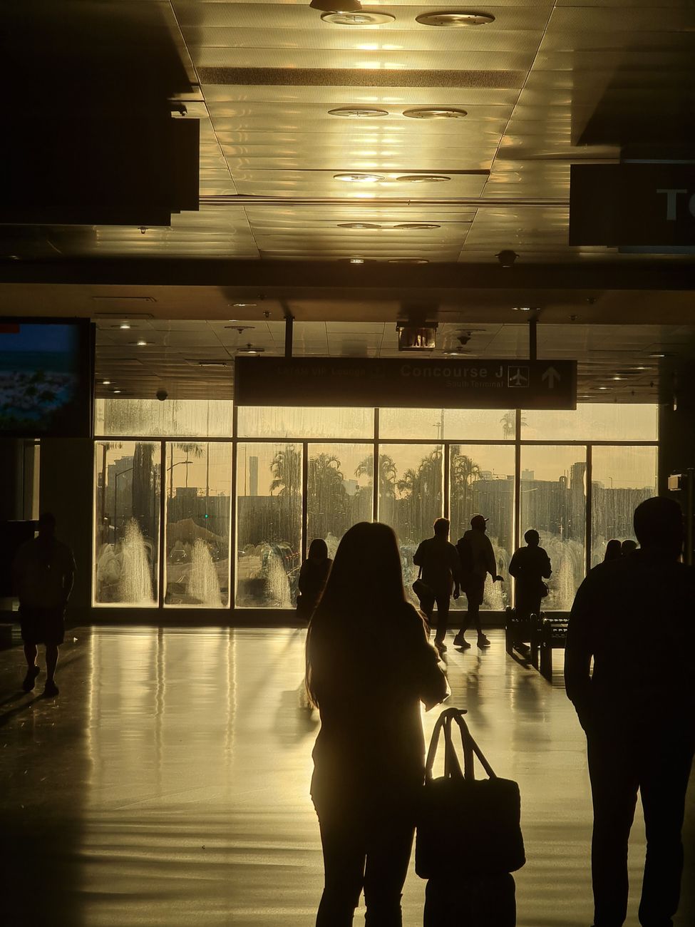 silhouette of travelers in miami airport terminal