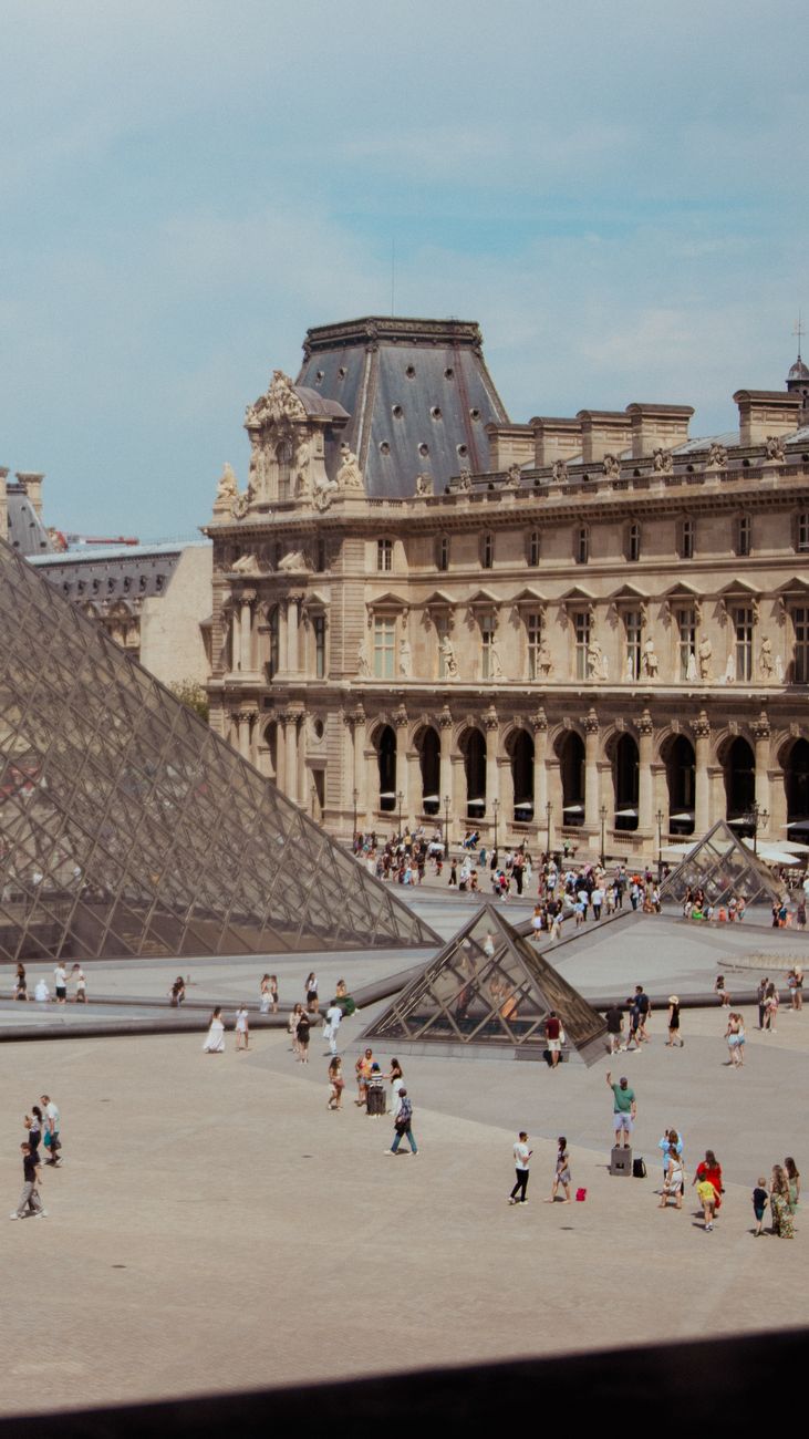louvre museum with glass pyramid in paris