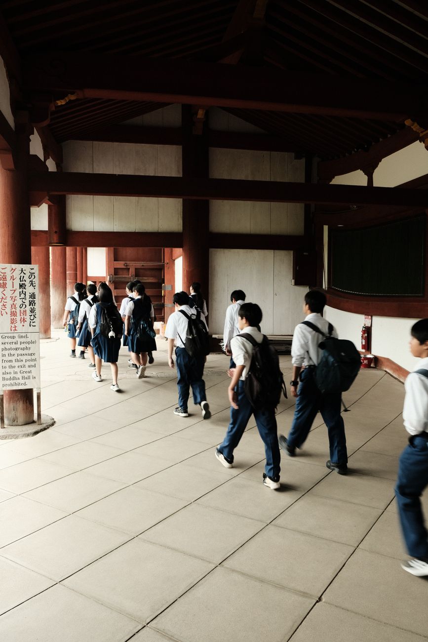 group of students in traditional school uniforms indoors